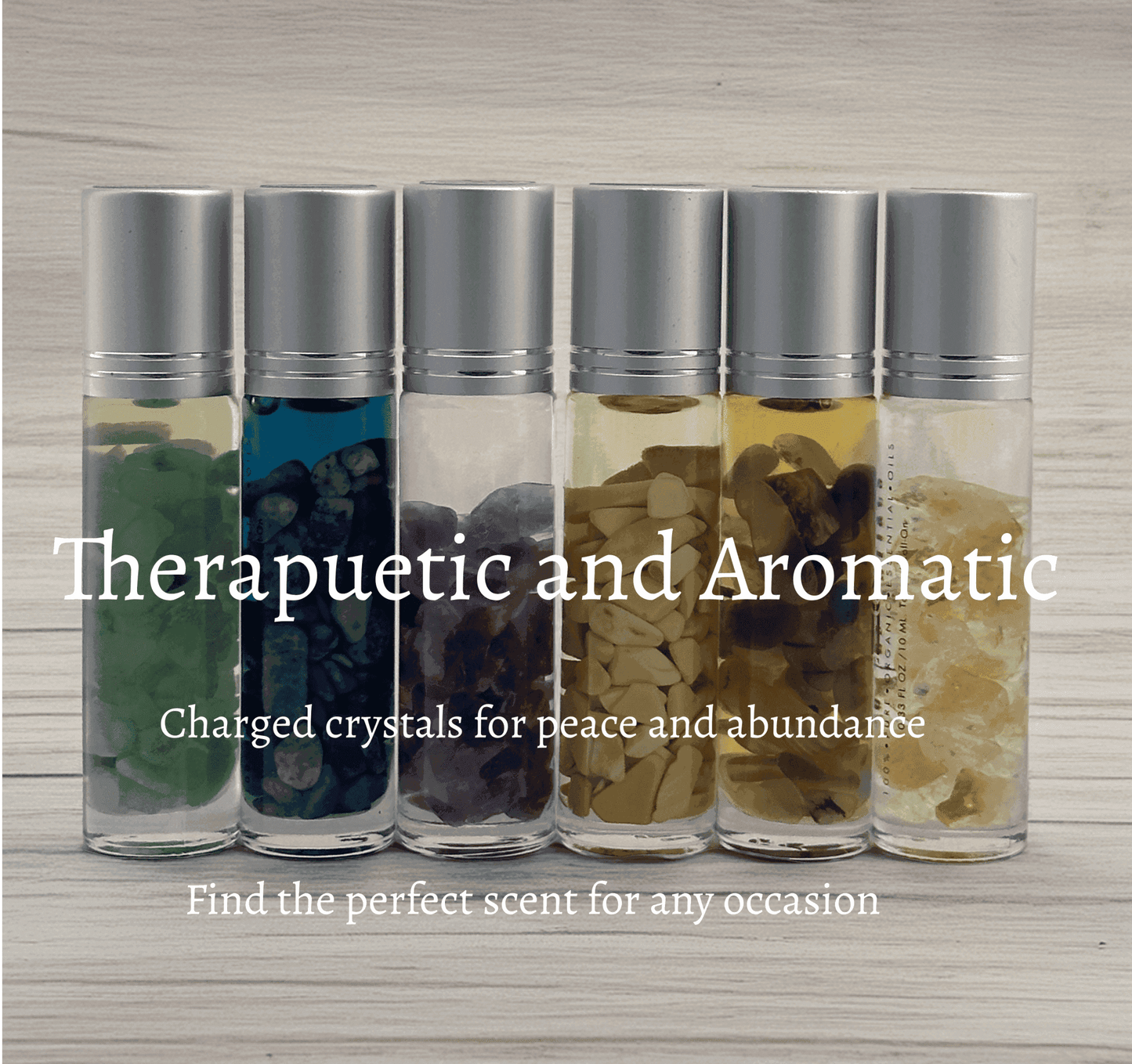 Six MounEssentials Sandalwood Essential Oil Infused Tiger Eye Roll-Ons are arranged before a light wood background. Therapeutic and aromatic, these charged roll-ons promote tranquility and abundance for any occasion.