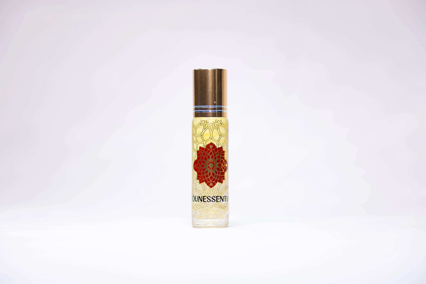 Citrine-infused lemon roll-on in clear glass bottle with gold cap and red floral design