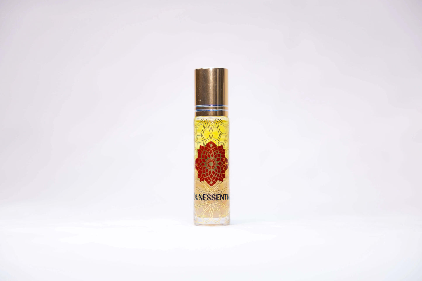 Clear glass rollerball bottle with gold cap, red yellow floral design, labeled unessential, Plumeria and Sunstone Infusion Body Roll