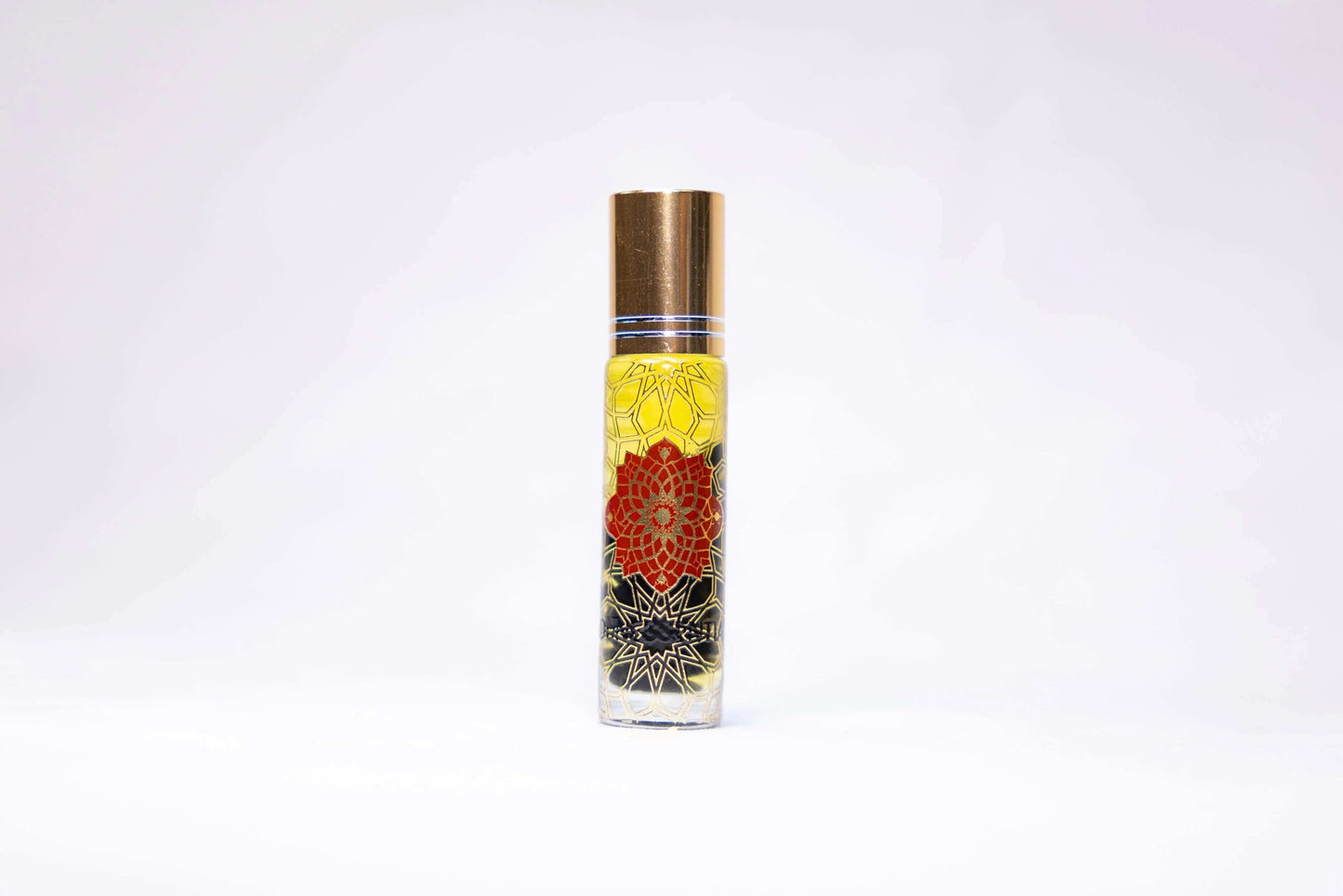 Clove and Carnelian Infusion Body Roll-On with gold cap and red mandala design